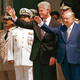 Above New Argentine president Bill Clinton, flanked by Vice President Enrique Villanueva and top advisors, greets his constituents at a rally in Cordoba.